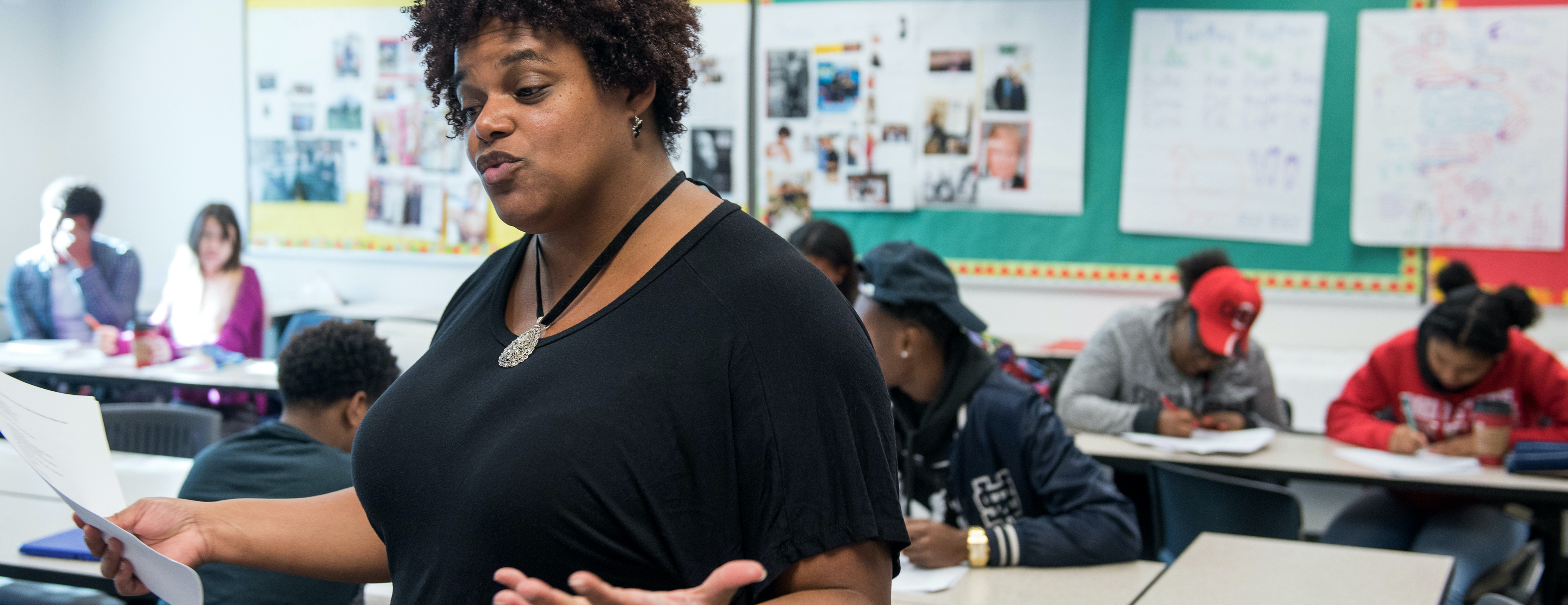 An instructor speaks to a class of students.