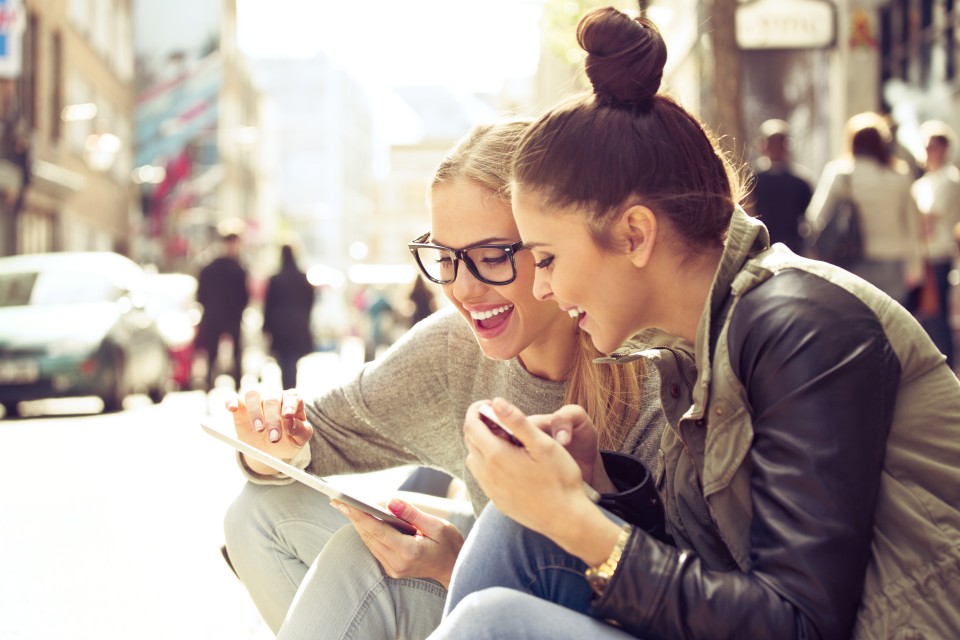 Two female students looking at an ipad