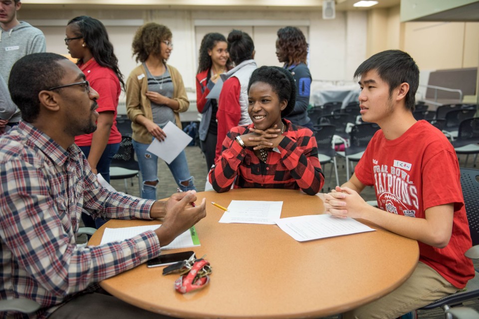 Instructor sitting with students.