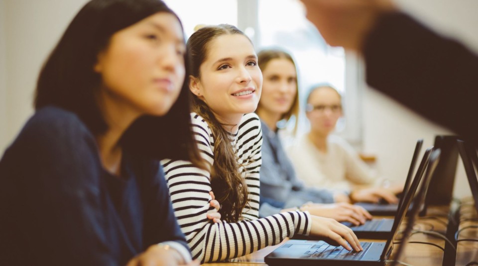 Row of female students in classroom