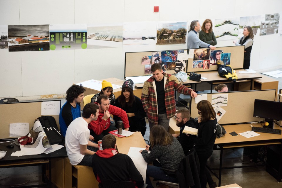 A group of students gathered around a class project.