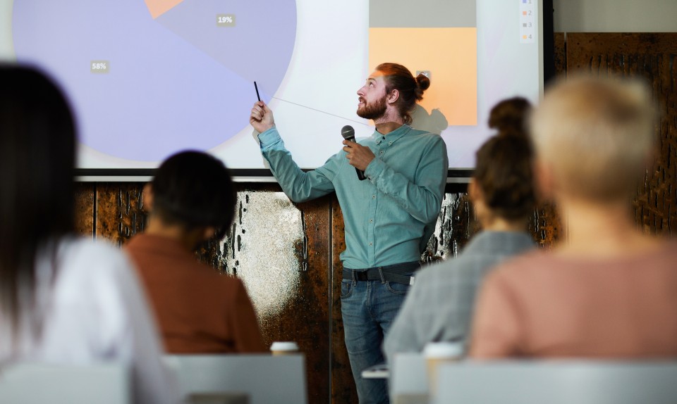 An instructor lectures to a class.