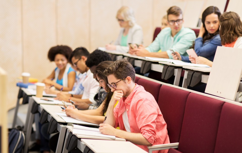 Students working together on an activity in a lecture hall.