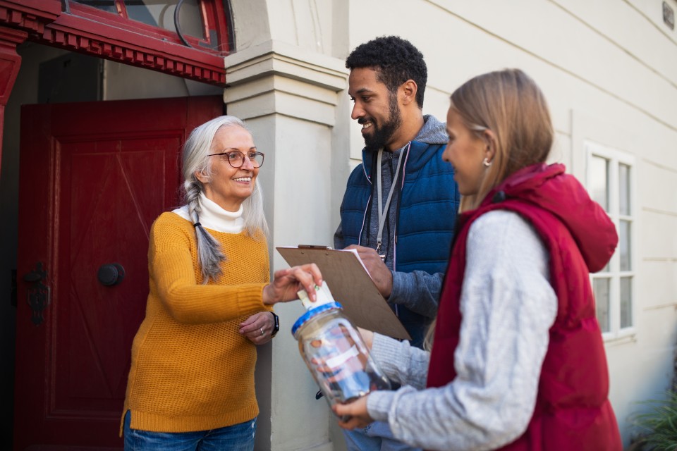 Students canvassers speaking to a community member.