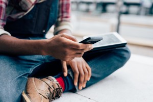 Student scrolling on smartphone